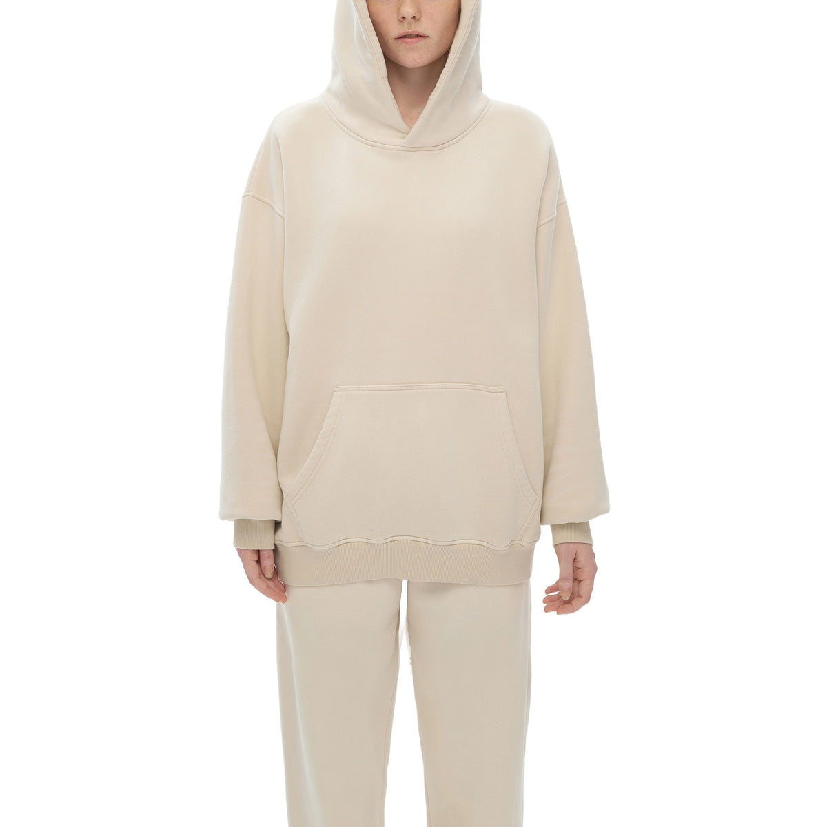 Model wearing a matching cream fleece hoodie and sweatpants set – custom printed apparel