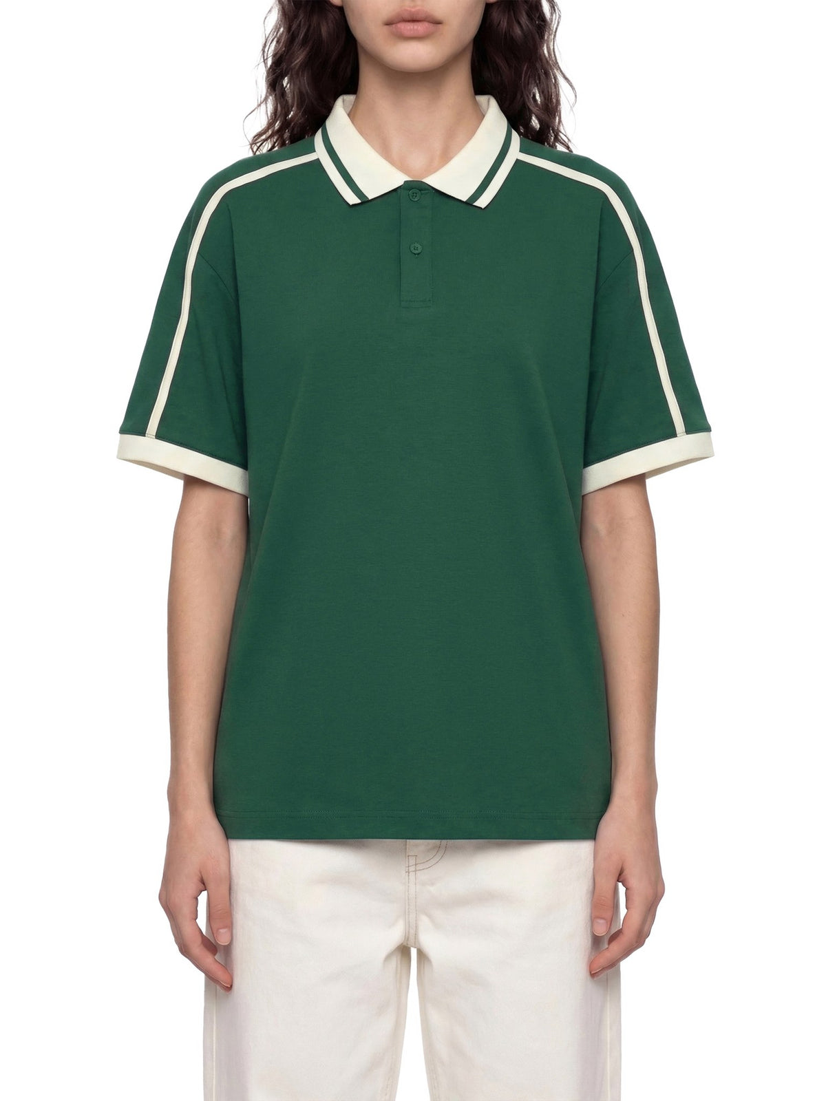 Model wearing a green polo shirt with cream contrast trim – custom printed apparel